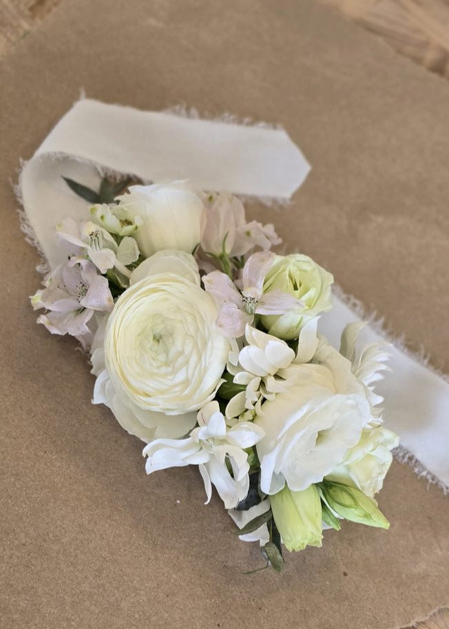 Twiggies white floral corsage made with premium flowers. 